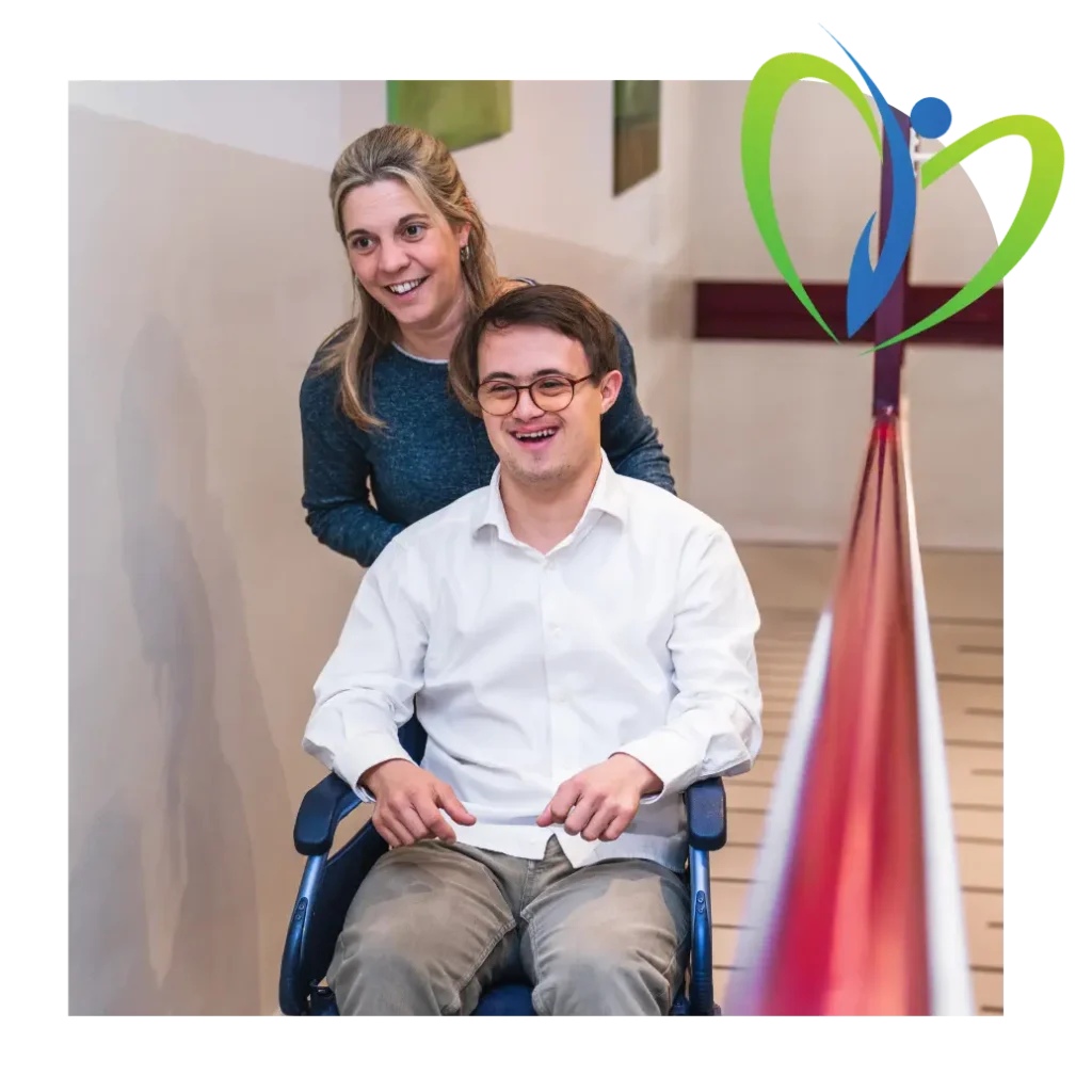 Happy disabled man in wheelchair with support worker